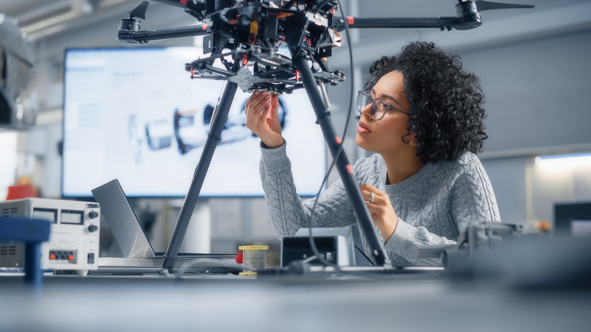 Concentrated Black Female Engineer Writing Code. Developing Software for Modern Drone Control in the Research Center Laboratory. Technological Breakthrough in Flight Industries Concept.